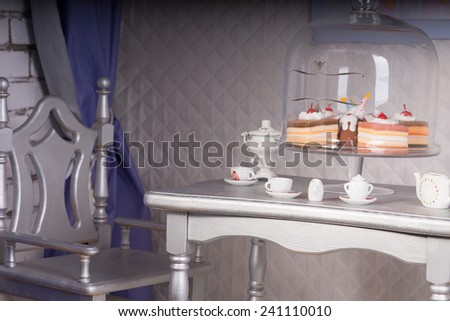 Close Up of Silver Dining Room Table Set for Tea with Variety of Decadent Cakes