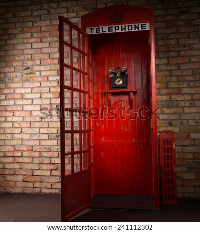 Full Length Image of Red Public Telephone Booth with Old Fashioned Telephone and Open Door