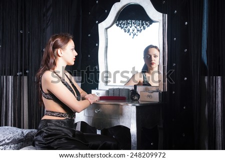 Sitting Gorgeous Woman, Looking at Camera Through Mirror Inside her Room, While Waiting.