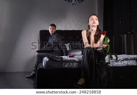 Young Lovers in Formal Clothes Sitting at the Bedroom Having Misunderstanding