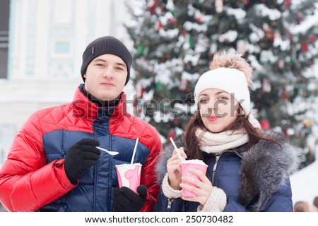 Close up Young Sweethearts in Winter Outfits Holding Milkshake While Looking at Camera