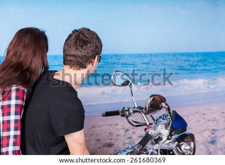 Rear View of Young Couple on Motorcycle Admiring View of Waves on Shore at Beach
