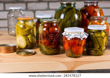 Variety of Jars of Pickled Vegetables on Wooden Table, Selection of Preserved Vegetables For Sale at Farmers Market