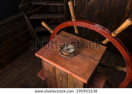 High Angle View of Helm of Antique Wooden Ship with Compass and Steering Wheel on Deck
