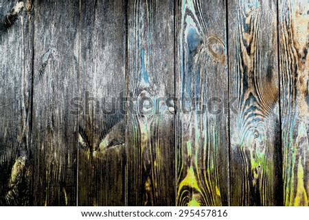 Close up full frame of rustic authentic wooden boards of floorboards or a fence, yellow and green tints visible in wood grain and knots