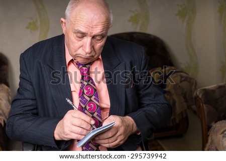 Close up Old Bald Businessman in Formal Wear, Writing Something on his Small Notes with Sad Facial Expression