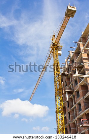 Construction of a new office building on blue sky background