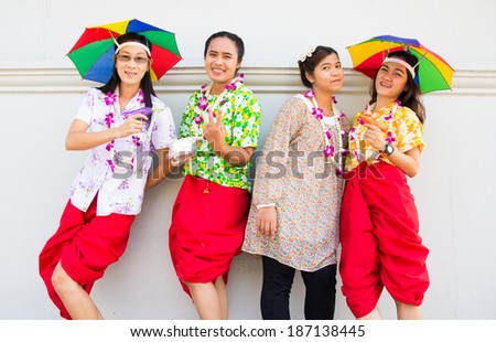 group of friends having fun in songkran festival at Thailand