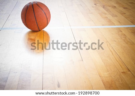 Basketball ball over floor in the gym Basketball ball over floor in the gym