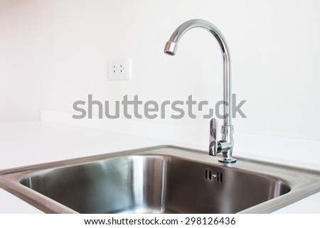 Water tap and sink in a modern kitchen.