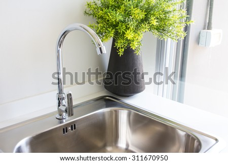 Water tap with sink in  modern kitchen.
