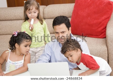 Portrait of family, dad and their children enjoying indoor with a laptop