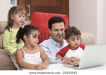 Portrait of family, dad and their children enjoying indoor with a laptop