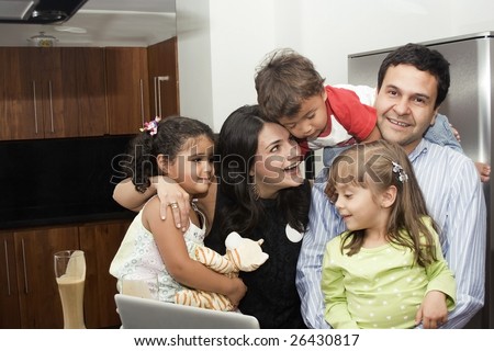 Portrait of beautiful family cooking in kitchen, dad, mom, daughters and little boy