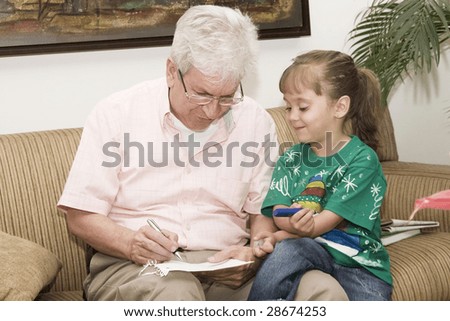 Portrait of family, grandfather enjoying with his granddaughter indoor