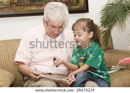 Portrait of family, grandfather enjoying with his granddaughter indoor