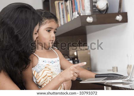 Mother teaching her daughter at home