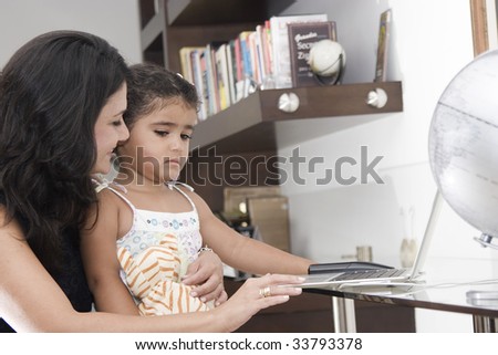 Mother teaching her daughter at home