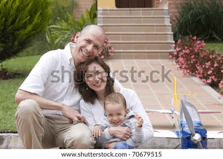 Portrait of family, mom and dad enjoying their son and airplane