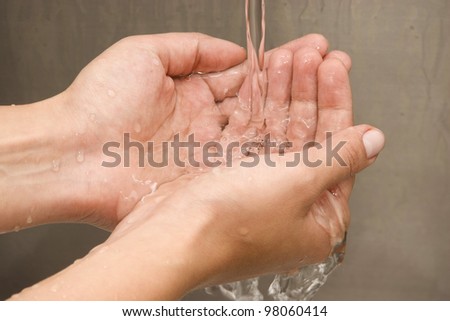 Woman Washing hands Under Running Water White Sink Chrome spout