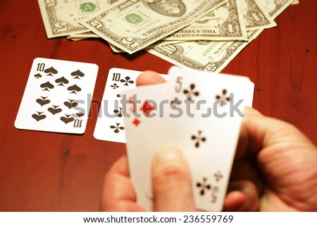 playing cards in hand of the player in poker