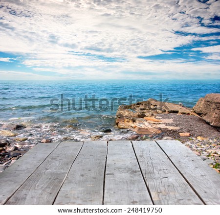 old wooden jetty and rocky shore ocean