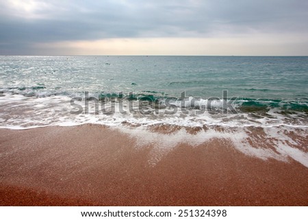 Sandy beach and the waves of the Mediterranean Sea