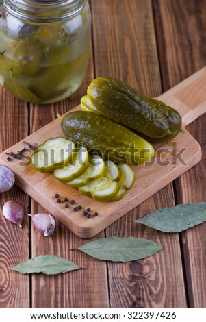 Pickles in can with garlic and pepper on a table