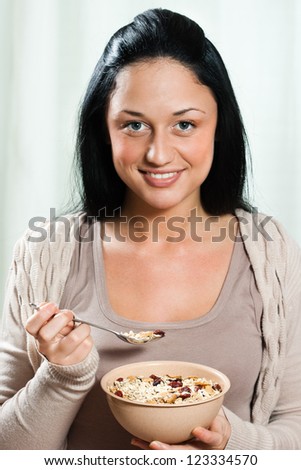 Young beautiful woman eating for breakfast cereals,Healthy meal