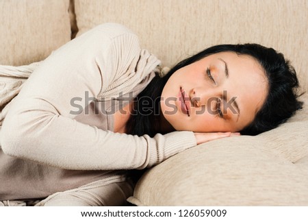 Beautiful young woman is sleeping on the sofa,Time for a nap
