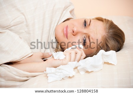 Young sad woman is lying in her bed and crying,Sad woman