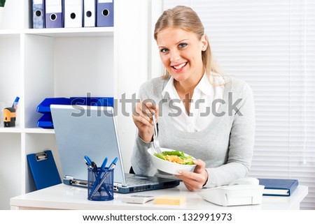 Beautiful businesswoman is having healthy lunch in her office,Healthy meal
