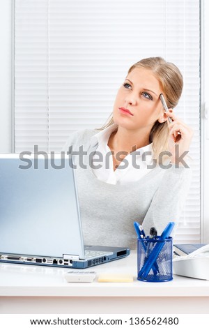 Young businesswoman sitting in her office and thinking,Businesswoman thinking