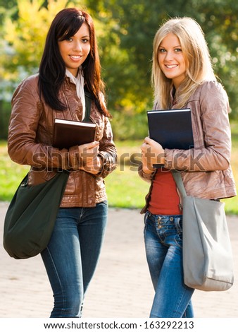 Portrait of two beautiful students in the park,Ready for education