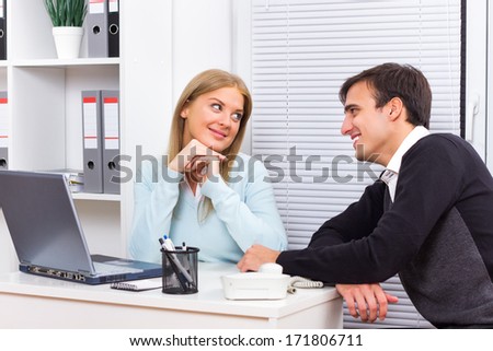 Young woman is flirting with her boss at work,Flirting at work
