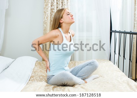 Young woman having pain in back,Backache