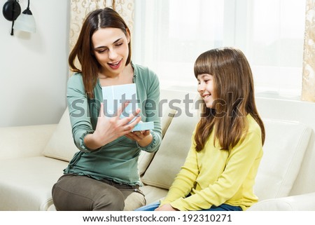 Mother is opening present from her daughter,she is very happy,it is just what she needed,You got it my dear,it`s exactly what I wanted!