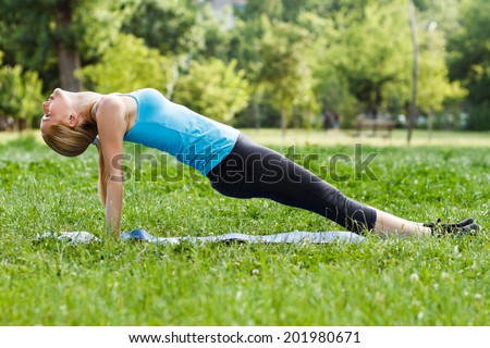 Beautiful blonde woman exercising in the park,Exercise