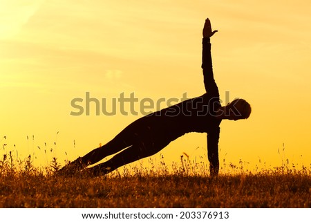 A silhouette of a woman practicing yoga,Yoga-Vasisthasana/Side plank pose