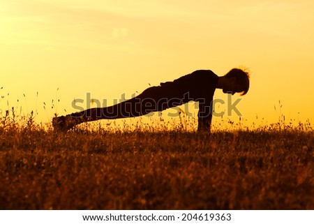A silhouette of a woman practicing yoga,Yoga-Dandasana /Plank pose
