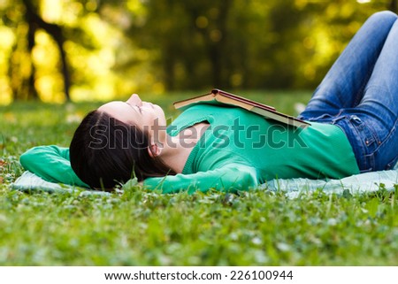 Young woman lying down in nature and sleeping,Resting in nature