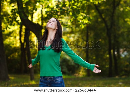 Beautiful young woman enjoys in nature,Peace of mind in nature