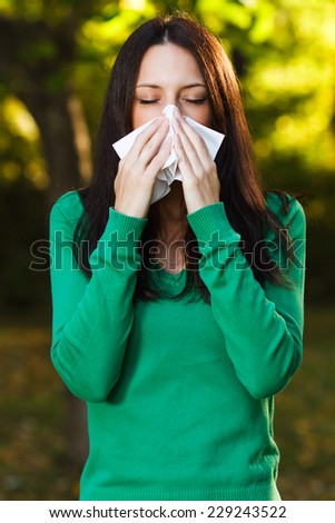 Woman is sneezing into handkerchief,Woman blowing nose