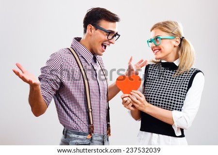 Nerdy woman is about to give a red heart  to her  boyfriend to show that she loves only him,My hearts belongs to you!