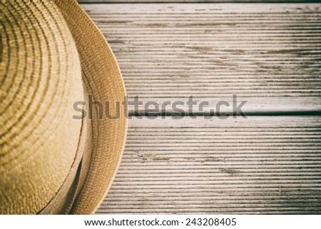 Photo of hat  on wooden table,intentionally toned image.Hat on wooden table