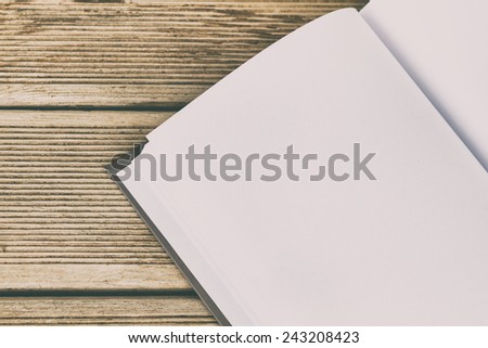 Photo of blank book on wooden table,intentionally toned image.Unwritten stories