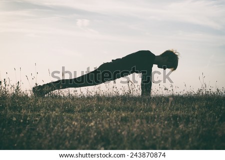 Woman practicing yoga,intentionally toned image.Yoga-Dandasana /Plank pose