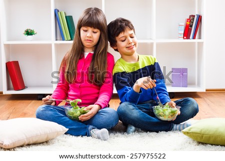 Little girl and little boy don\'t want to eat vegetables.We don`t like vegetables!