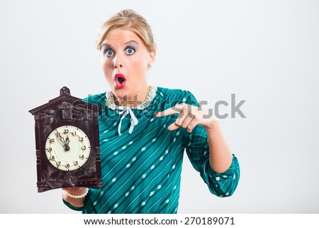 Retro woman is holding clock and showing that time is running out very fast.Time