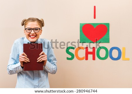 Cute geek girl is excited because she loves to learn.I love to learn!
